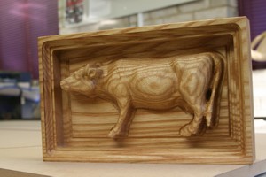 Small model cow carved into Ash
